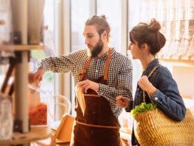 Man wearing checkered shirt serving lady wearing denim jacket