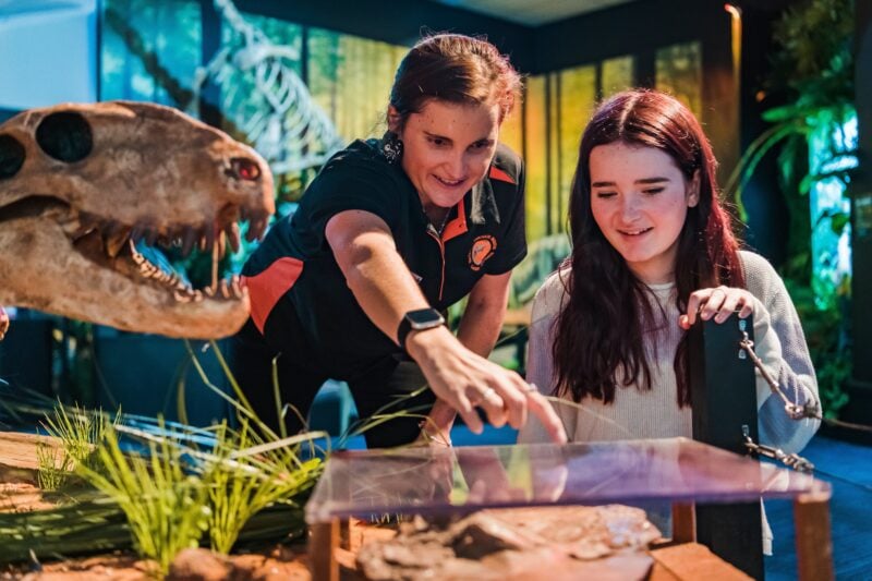 Tour Director, Nicole, points to a plague with teenage girl