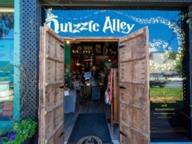 Quizzic Alley's entrance, flanked by impressive timber castle doors.