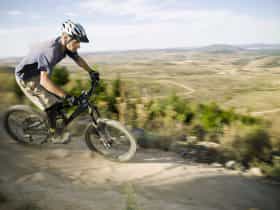 A man riding a mountain bike at Stromlo Forest Park