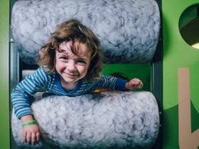 Photo of a child climbing through the sheeps pen