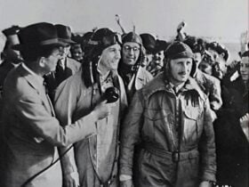 Black and white image of pilots surrounded by media