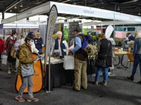 People standing at COTA ACT Expo stall