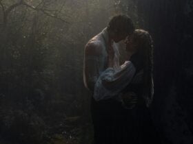 A woman and man embrace in the rain