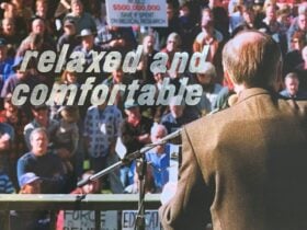A press photo of John Howard giving a public speech with 'relaxed and comfortable' to the left