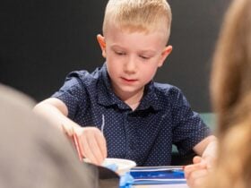A child doing craft at a table