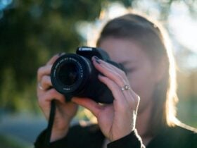 Photograph of a woman taking a photograph with a digital camera