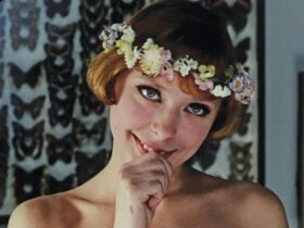Young woman with a bob haircut and flower crown with thumb in mouth