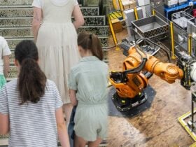 Three children with a guide and titan the robot pouring coins