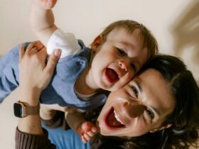 Smiling mother playing with laughing child