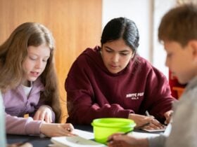 Three kids working on crafting activities