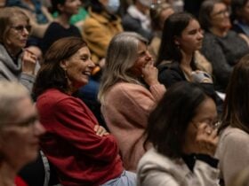 Crowd of people sitting in a theatre