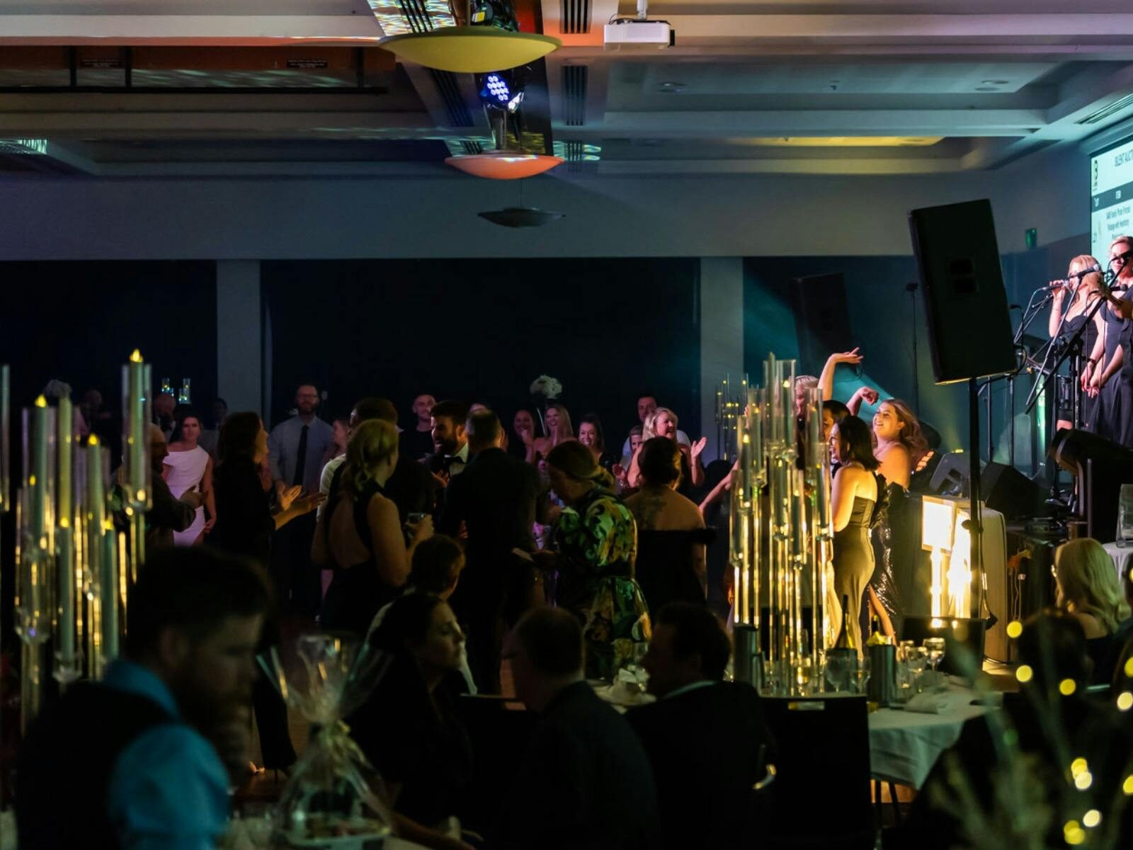 People dancing in room, lights and smiling