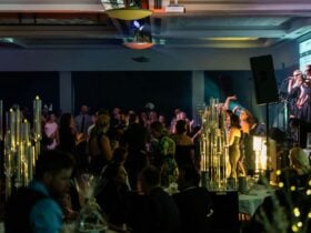 People dancing in room, lights and smiling