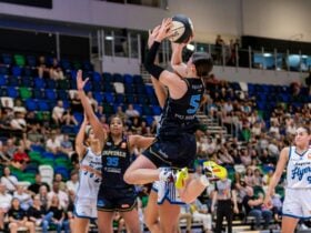 UC Capitals player shooting the basketball while a defender closes in.