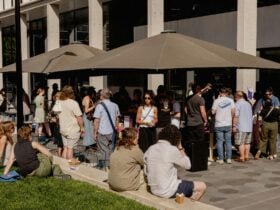 People enjoying Frenzy 2024 tasting wine and sharing community