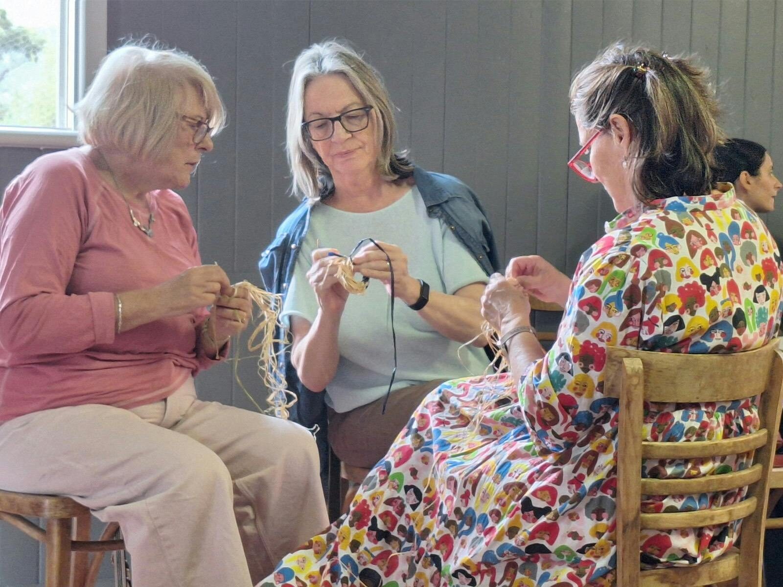 three ladies weaving
