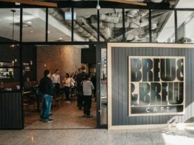 Front of cafe with doors open and people waiting to order