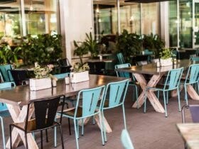Empty outdoor tables with blue and black seating