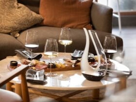 Wine and cheese laid out on a table with wine decanter