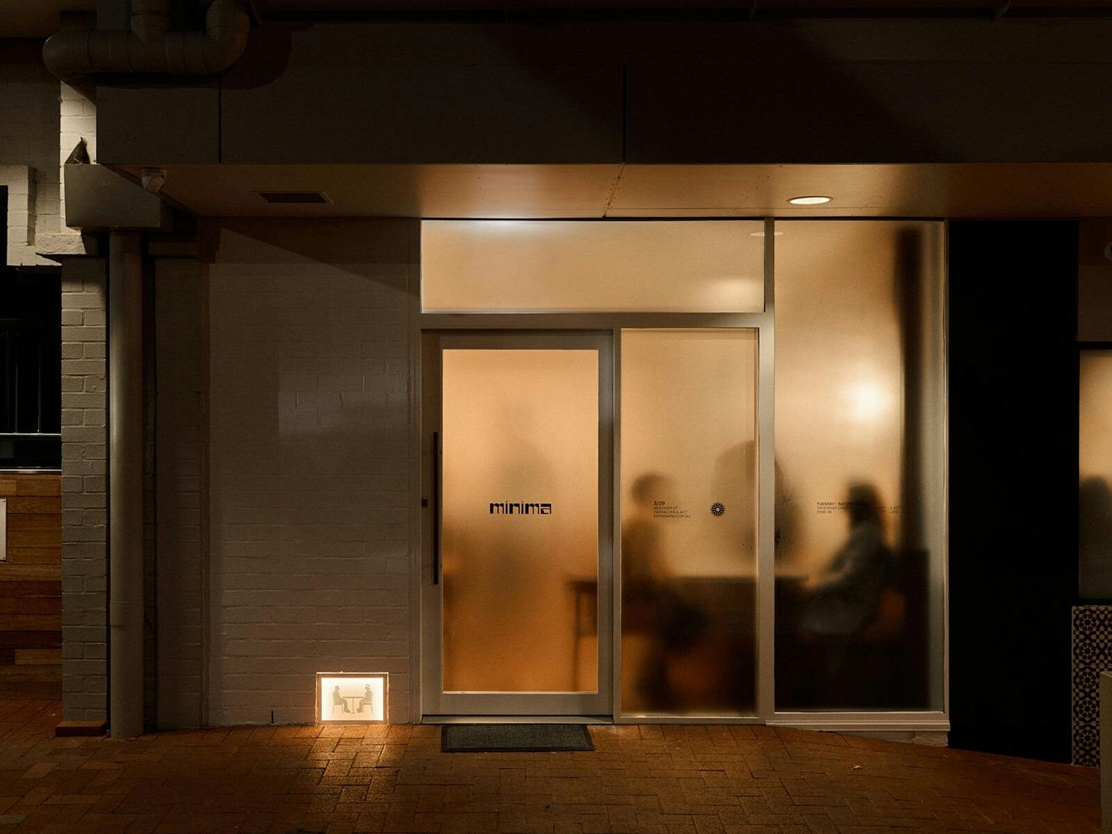 A buzzing restaurant behind frosted glass, subtly hiding what is inside.