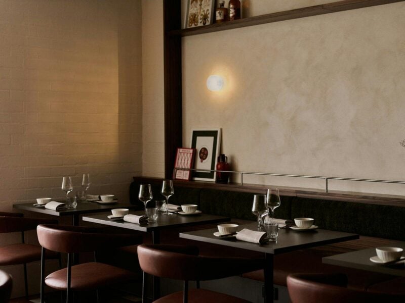 Three tables set with cutlery and glassware, comfortable chairs, and a dining room that feels homely