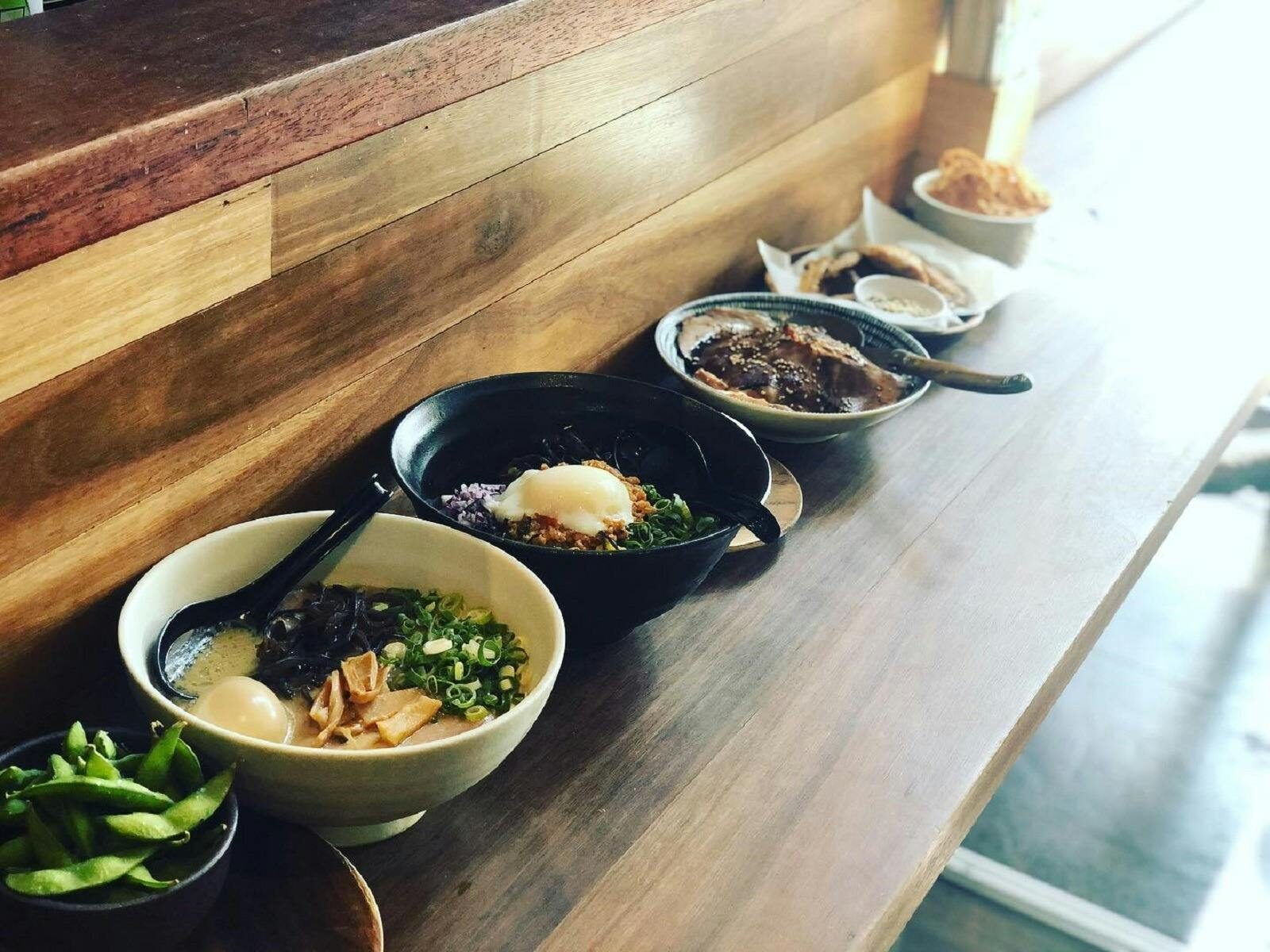 Bowls of ramen on long table