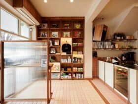 this photo shows a retail display of coffee and books, a front counter of a cafe and some vinyl