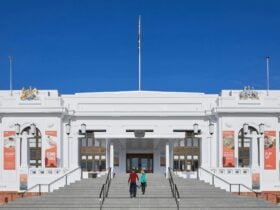 Two people walk up the steps of Old Parliament House