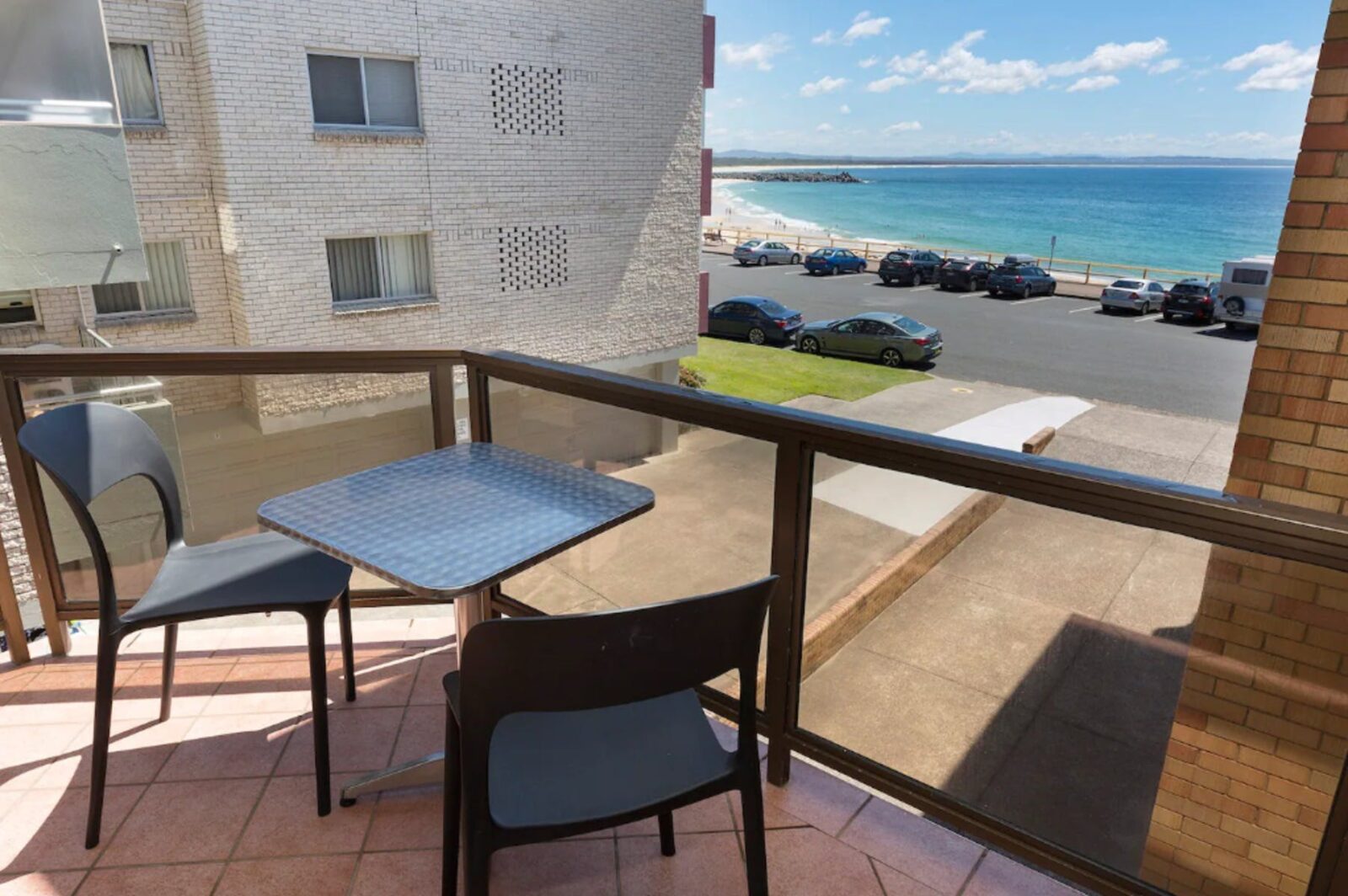 Balcony with beach views and 2 seater outdoor setting