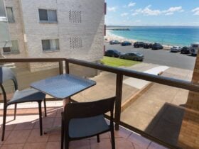 Balcony with beach views and 2 seater outdoor setting