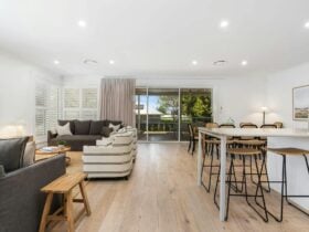 Kitchen, lounge and dining area with sliding doors to the deck