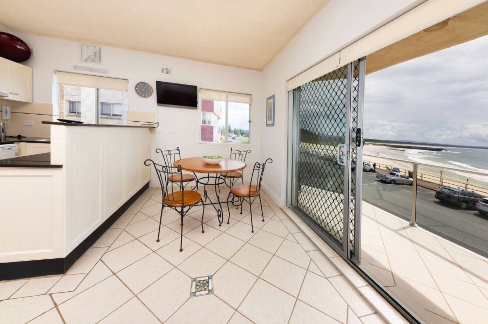 Kitchen and dining area with 4 seater dining setting and uninterrupted beach views