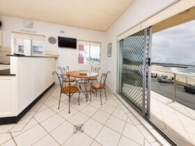 Kitchen and dining area with 4 seater dining setting and uninterrupted beach views