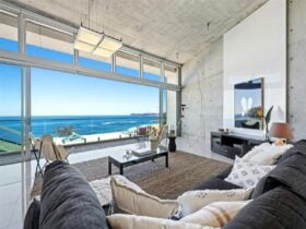 formal lounge commands a breathtaking view of Forresters Beach