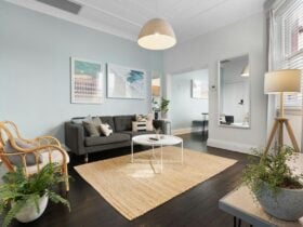 Open living area with a comfy couch, natural light, and stylish decor.