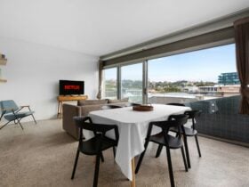 Stylish dining area and lounge leading to an outdoor balcony.