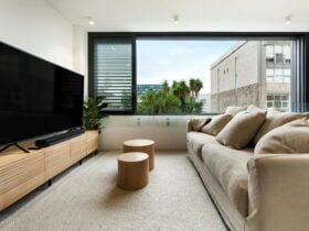 Bright living room with large windows and a comfortable couch.