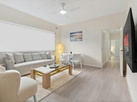 Bright and cozy living room with a sofa, coffee table, and TV.