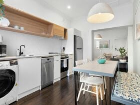 Modern kitchen with stylish design, appliances, and a dining area.