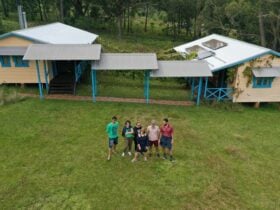 Group standing in front of ecocabins