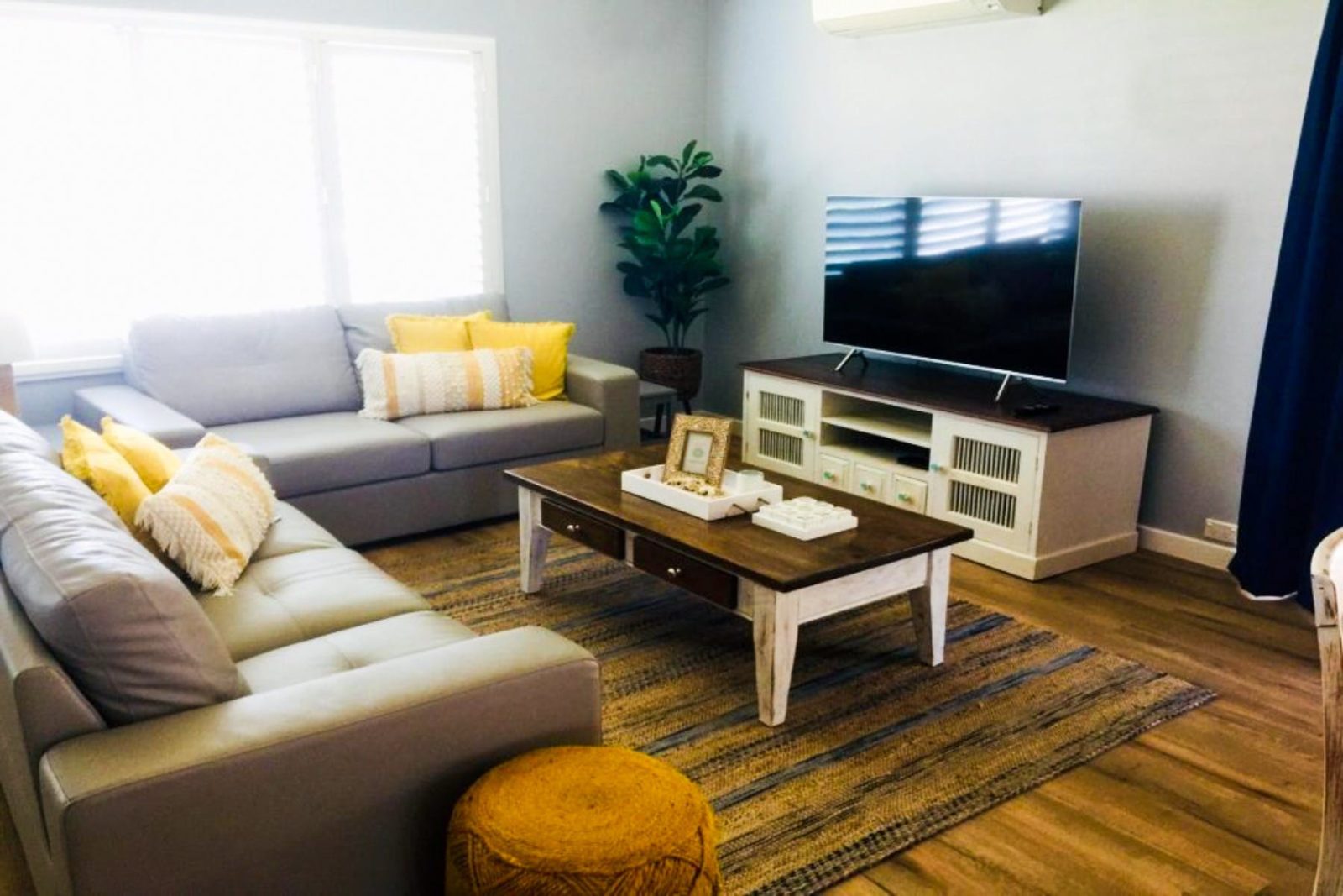 The lounge room is spacious and features a comfortable lounge with Smart TV