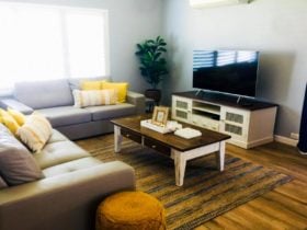 The lounge room is spacious and features a comfortable lounge with Smart TV