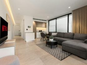 Living room with comfortable couch and Netflix TV setup.
