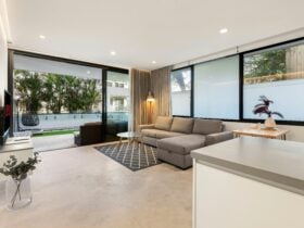Bright living room with a plush sofa and outdoor terrace view.
