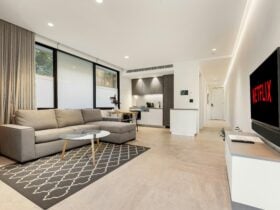 Bright living room with a plush sofa and outdoor terrace view.