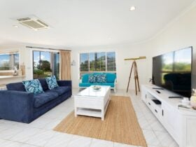 Lounge room with lounges, TV, telescope and air-conditioning