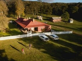 A bird's eye view of a couple walking towards Currango Homestead, Kosciuszko National Park. Photo: