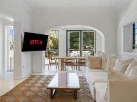 Living room with cozy sofa and dining area with outdoor balcony access.