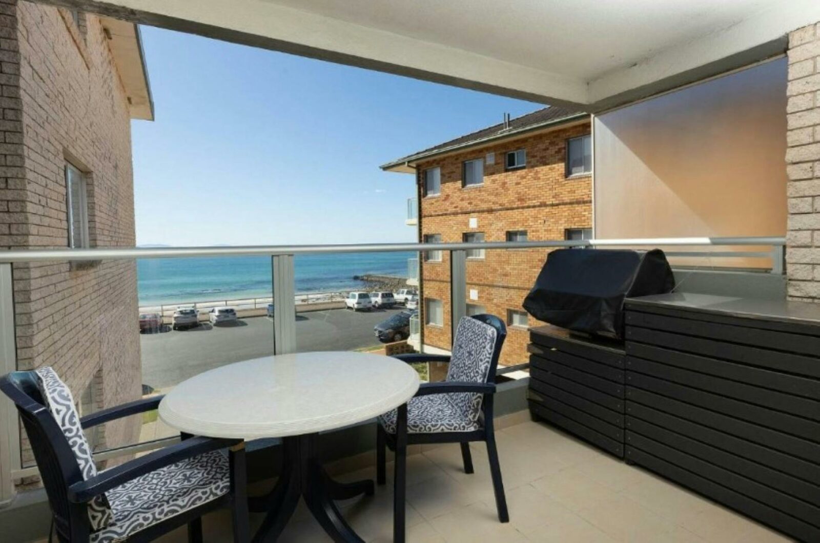 Balcony with 2 seater setting, BBQ and gorgeous beach views